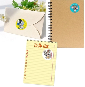Close-up of colorful cartoon reward stickers on a notebook and envelope for kids