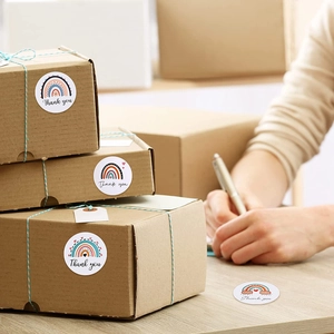Rainbow thank you stickers applied on eco-friendly kraft gift boxes for packaging