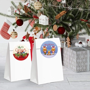 Christmas gift bags with festive stickers featuring reindeer and Merry Christmas text