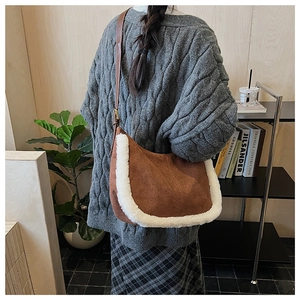 Chic brown suede Hobo bag with plush faux shearling trim worn with a cozy grey sweater