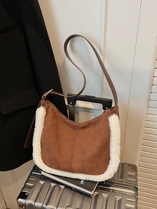 Brown suede underarm bag with white faux fur trim and adjustable leather strap