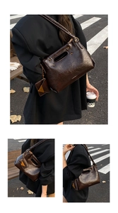 Detail of vintage brown oil-wax tote bag with unique hollow handle and triangle pouch