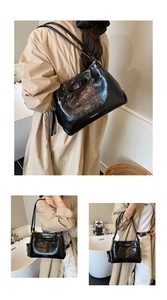 Detail of glossy black pleated tote bag with versatile shoulder straps for business use