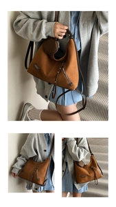 Detail of a brown suede hobo tote with leather trim and matching round coin purse charm