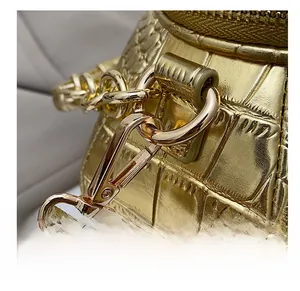 Detail of the high-quality gold metal hook and crocodile texture on the teapot bag