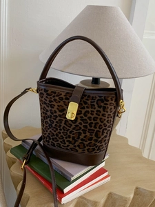 Sac seau vintage imprimé léopard avec bordure en cuir marron et détails dorés élégants