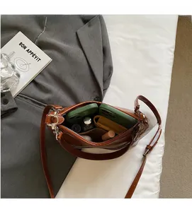 Spacious interior of brown baguette bag with compartments for essentials