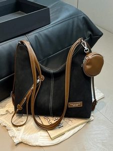 Fashionable black suede tote bag with brown leather straps and white contrast stitching
