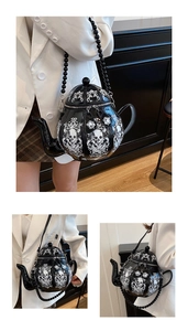 Creative black teapot shoulder bag with white skull patterns and a black bead strap detail