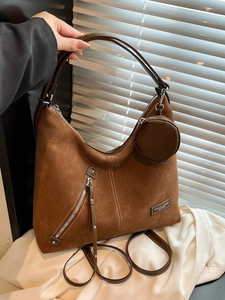 Brown suede tote bag with contrast stitching and round coin purse on handle