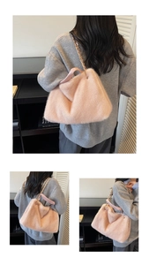 Pink faux fur handbag with gold chain strap shown on model in cozy interior setting