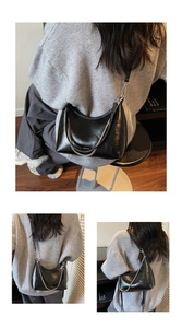 Close-up of black hobo bag with glossy finish and silver chain detail
