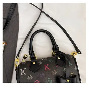 Detail of Boston bag showing lychee grain leather, letter K print and gold hardware