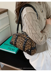 Detail of leopard print Boston bag with silver studs and black leather handles