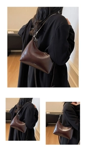 Detail of dark brown glossy hobo bag with metal chain and NO FILTER logo