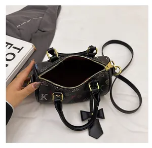 Top view of compact black Boston bag with colorful lettering and spacious red interior