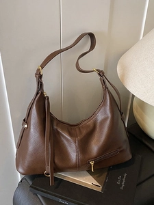 Dark brown pebbled leather hobo bag with gold zipper and adjustable shoulder strap