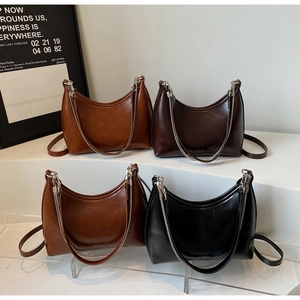 Detail view of four vintage hobo bags with silver chain decor and adjustable straps
