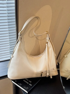 Minimalist cream white leather tote bag with side fringe and front zipper detail