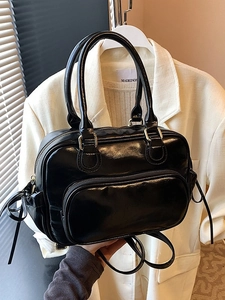 Glossy black patent leather backpack with bow drawstrings and golden hardware for women