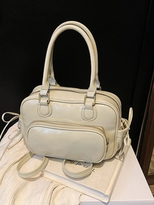 Creamy white Boston style faux leather handbag with dual handles and front arch pocket