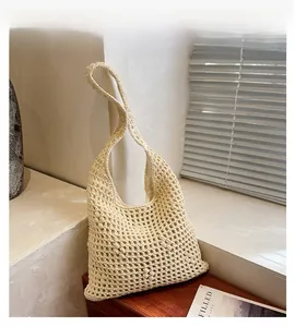 Detail of hand-woven beige cotton tote bag featuring intricate openwork crochet patterns
