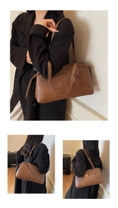 Detail view of brown vintage leather shoulder bag with side drawstring and metal logo