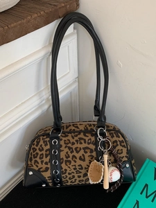 Leopard print bowling bag with black leather handles and baseball themed charms