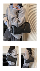 Detail of minimalist black leather underarm bag with metal logo and tassel drawstring