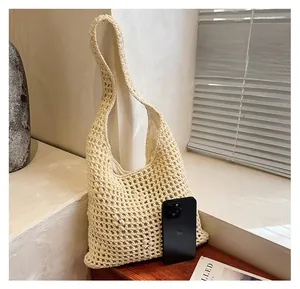 Macro detail of cream woven tote bag with hollow mesh pattern and phone size reference