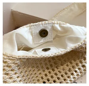 Close-up of woven beach bag featuring secure silver magnetic buckle and soft inner lining