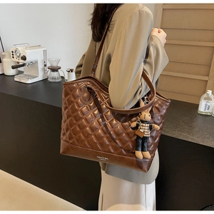 Quilted brown PU leather tote bag with fashion embossing and a cute rabbit charm