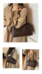 Close-up of vintage coffee leather tote bag showing fine stitching and drawstring detail