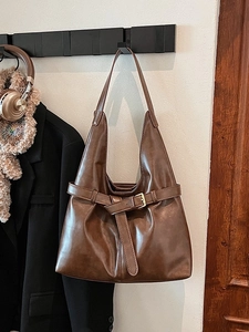 Large dark brown hobo shoulder bag in glossy oil wax leather with metal buckle detail