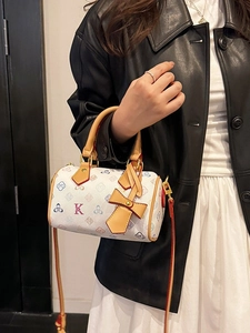 Classic monogram boston bag with bow pendant and adjustable red strap for women