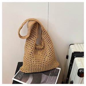 Detail of hand-woven hobo bag showing intricate hollow mesh texture and sturdy shoulder strap