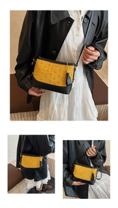 Détail du sac seau matelassé avec strass, daim jaune et base en cuir noir élégante