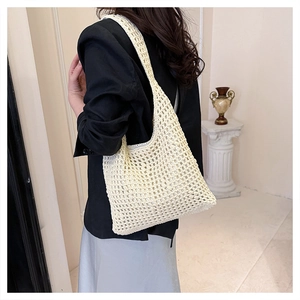 Close-up of a cream woven hollow tote bag showing the detailed crochet diamond pattern