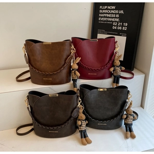Collection of four textured PU leather bucket bags in brown, red, coffee, and black tones