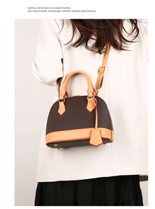 Vue détaillée du sac à main vintage en forme de dôme avec garniture en cuir marron