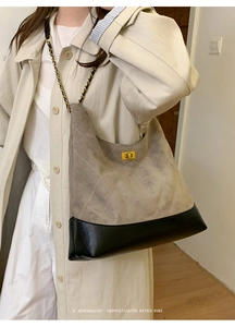 Detail of retro quilted tote bag with grey suede and black leather patchwork