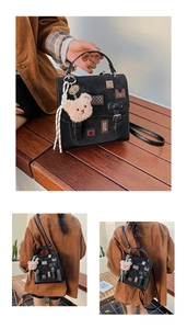 Detail of black crossbody bag featuring cartoon charms and a heart print decorative patch