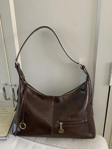 Deep brown oil wax leather tote bag with gold hardware and zipper pocket for office work