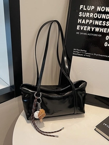 Minimalist black faux leather shoulder bag with chic baseball glove and ball charms