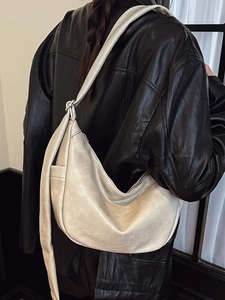 Fashionable creamy white crescent crossbody bag with knotted shoulder strap for women