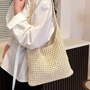 Minimalist cream woven hollow shoulder bag for beach travel with wide shoulder strap