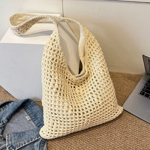 Chic cream hollow woven shoulder bag with inner lining shown in a casual lifestyle setting