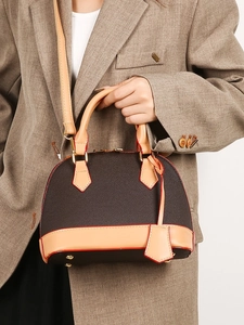 Sac à main cuir marron en forme de coquillage avec bords rouges et bandoulière réglable