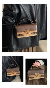 Detail of rhombic quilted stitching and vintage gold lock on the leather handbag