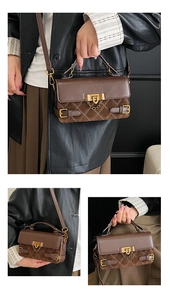 Detail view of brown quilted handbag featuring faux leather texture and vintage brass lock